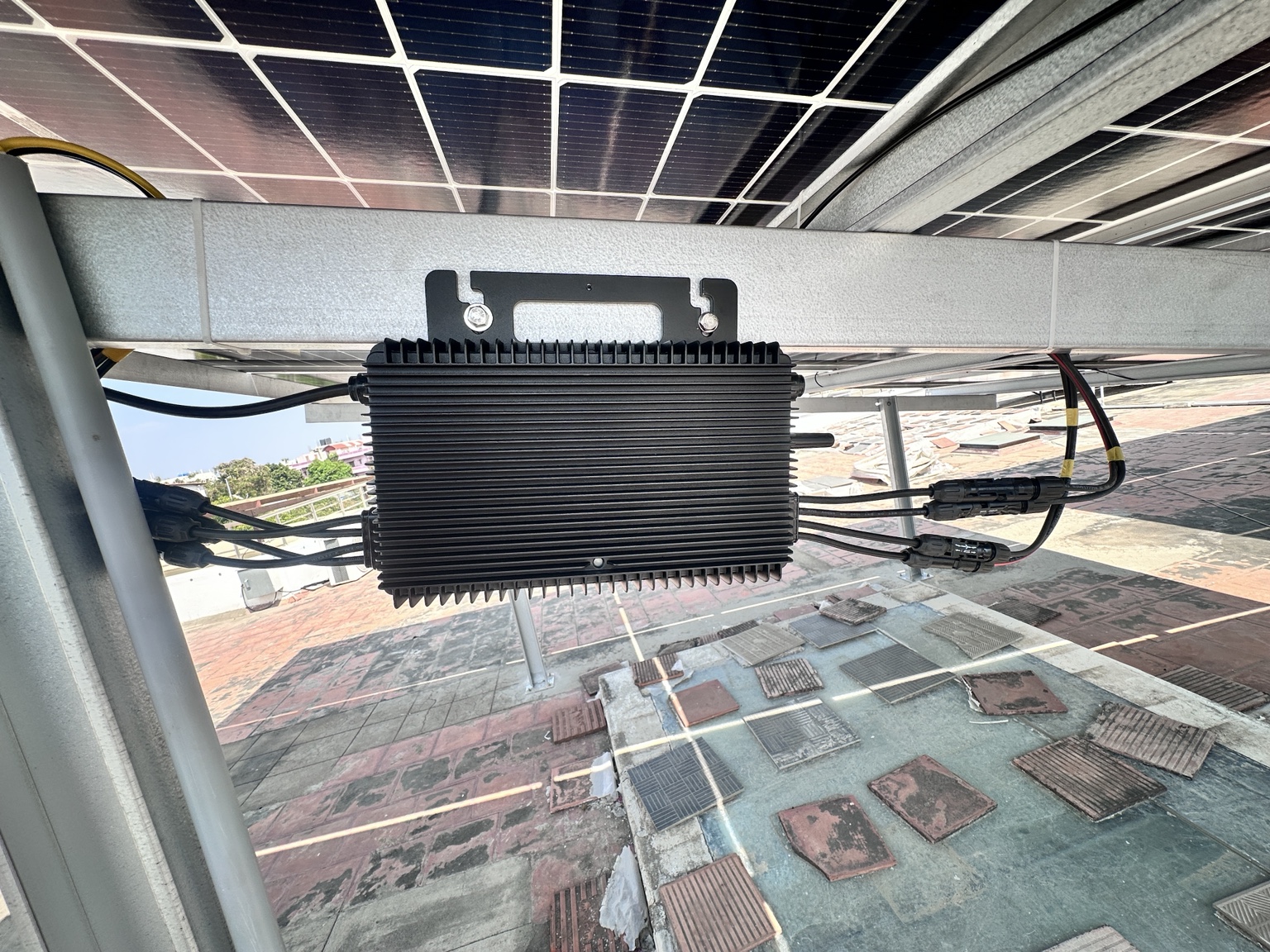 Microinverter installed beneath rooftop panels
