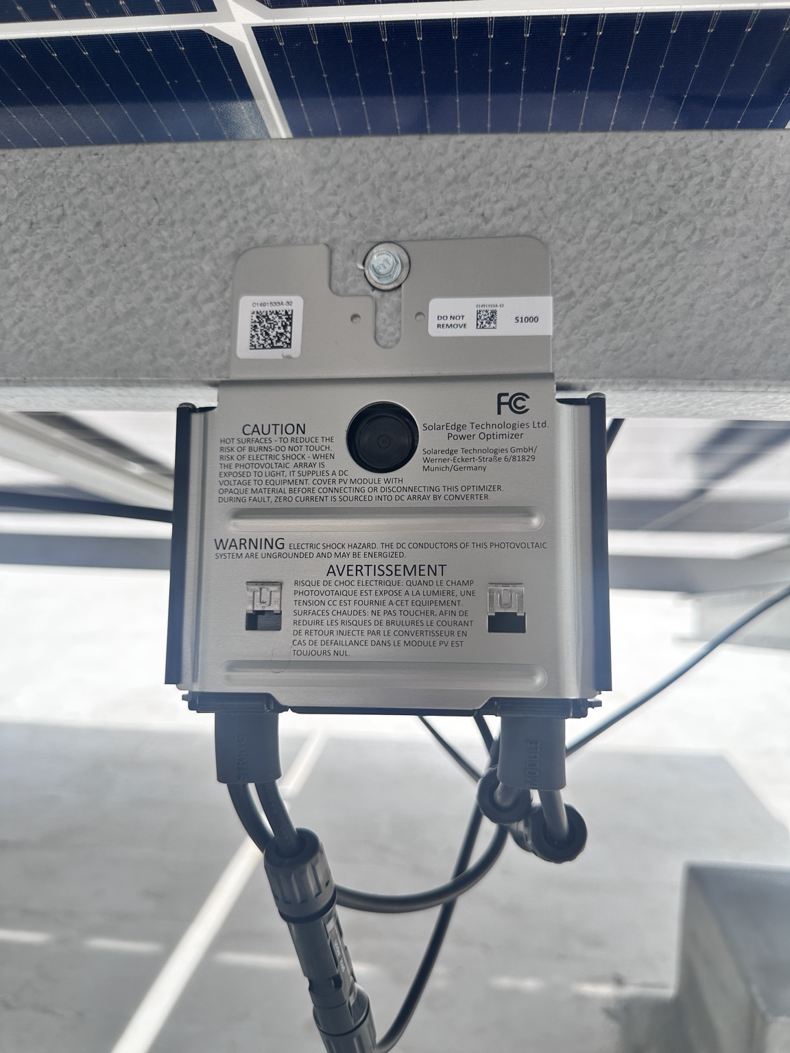 Microinverter mounted beneath a solar panel